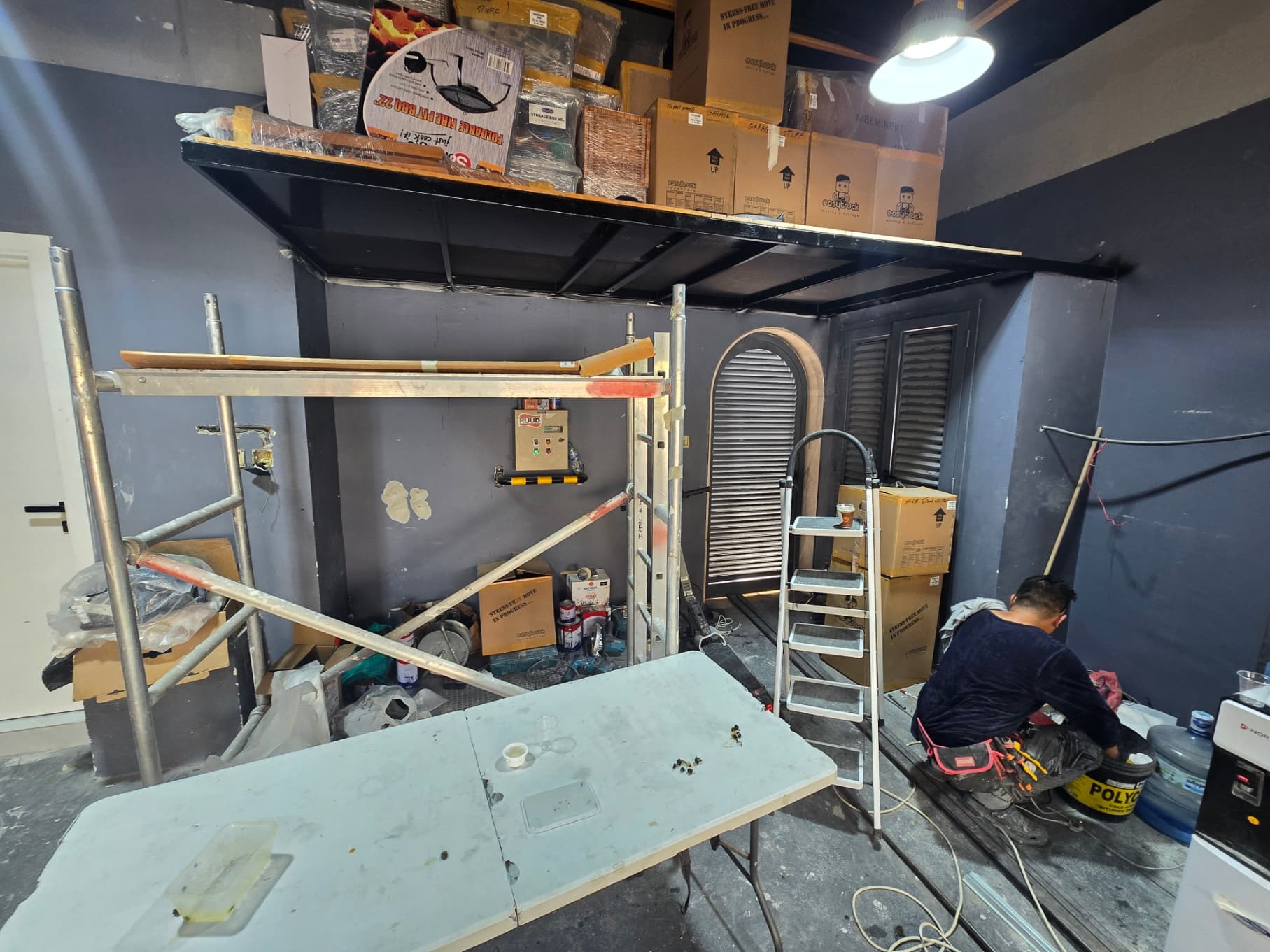 Work in progress at Villa G28 — mezzanine platform installed and the team fitting out beneath it