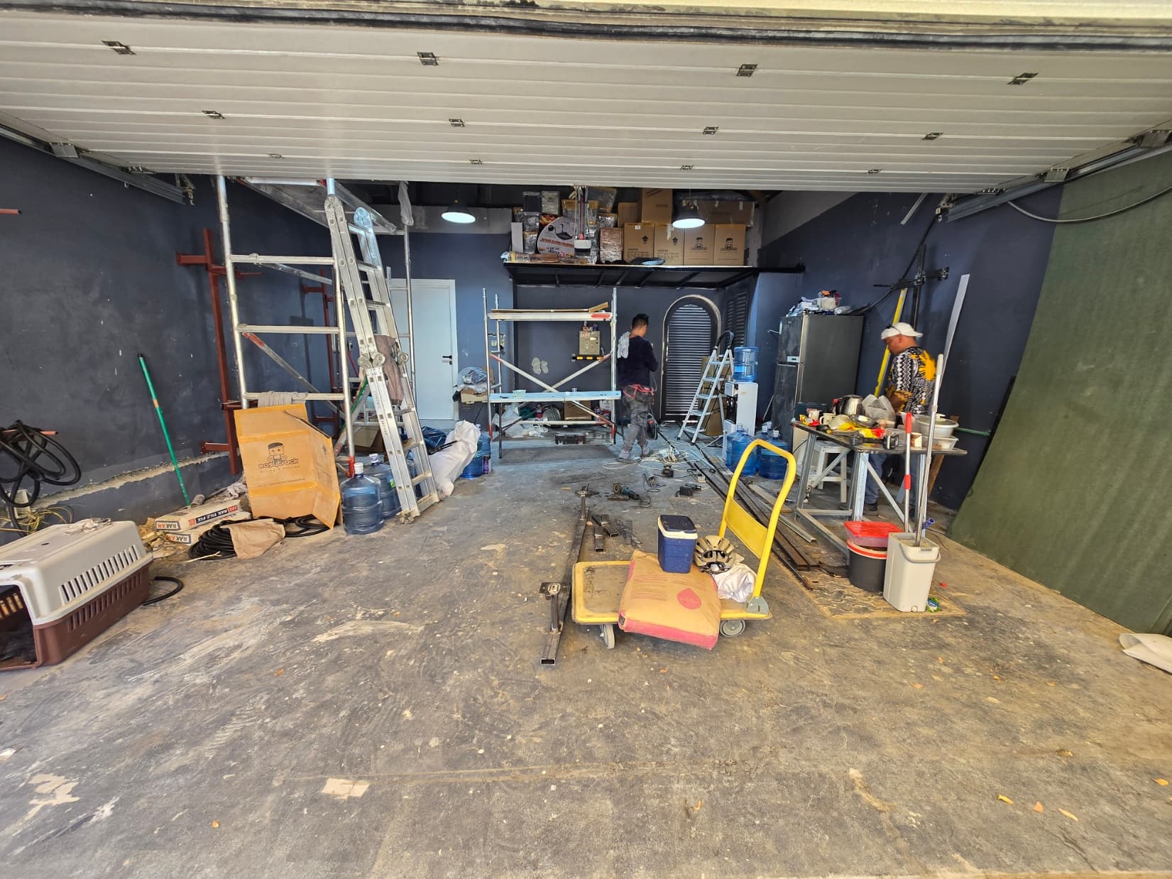 Work in progress at Villa G28: mezzanine storage platform installed, walls painted and the team fitting out the garage
